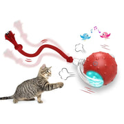 Tabby cat playing with a red interactive rolling toy ball featuring a dangling rope and light effects for feline entertainment.